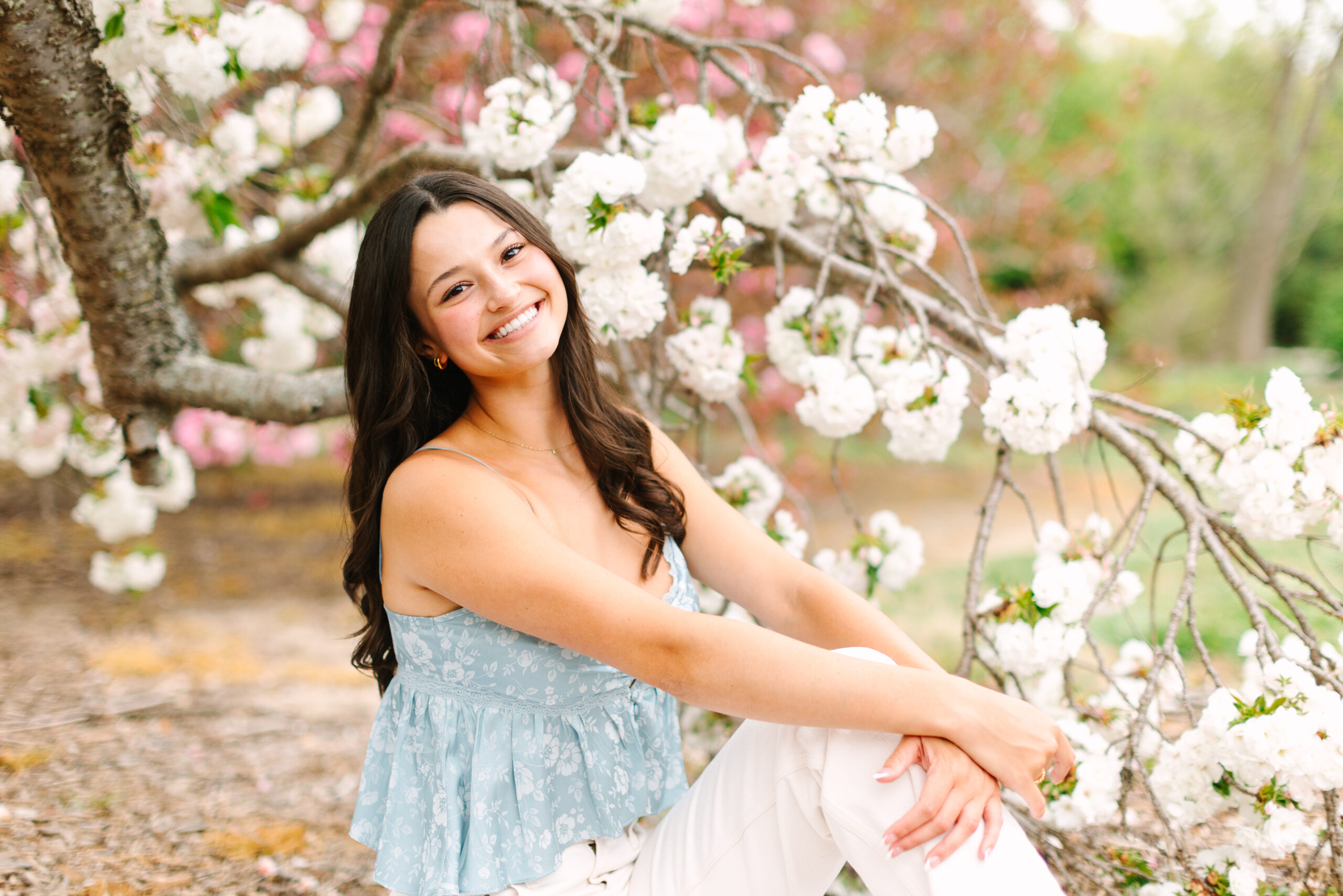 Senior portrait with floral backdrop and lush greenery at Norfolk Botanical Garden, VA
