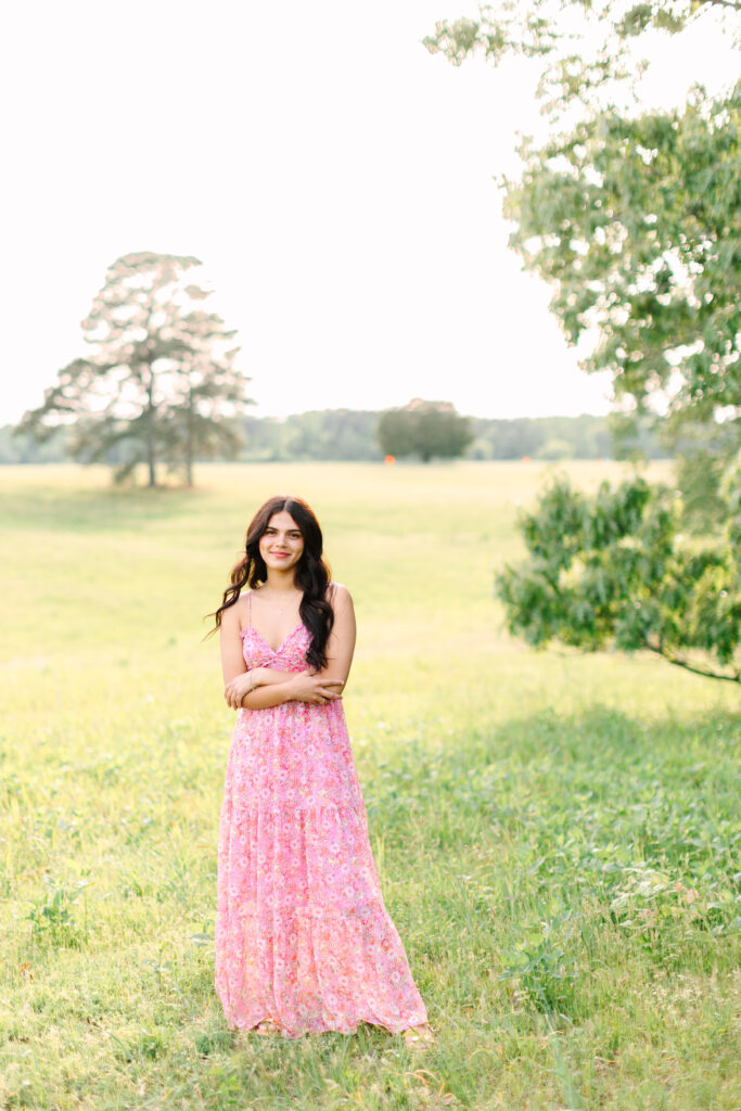 Senior girl confidently posing in the fields in Yorktown during her portrait session