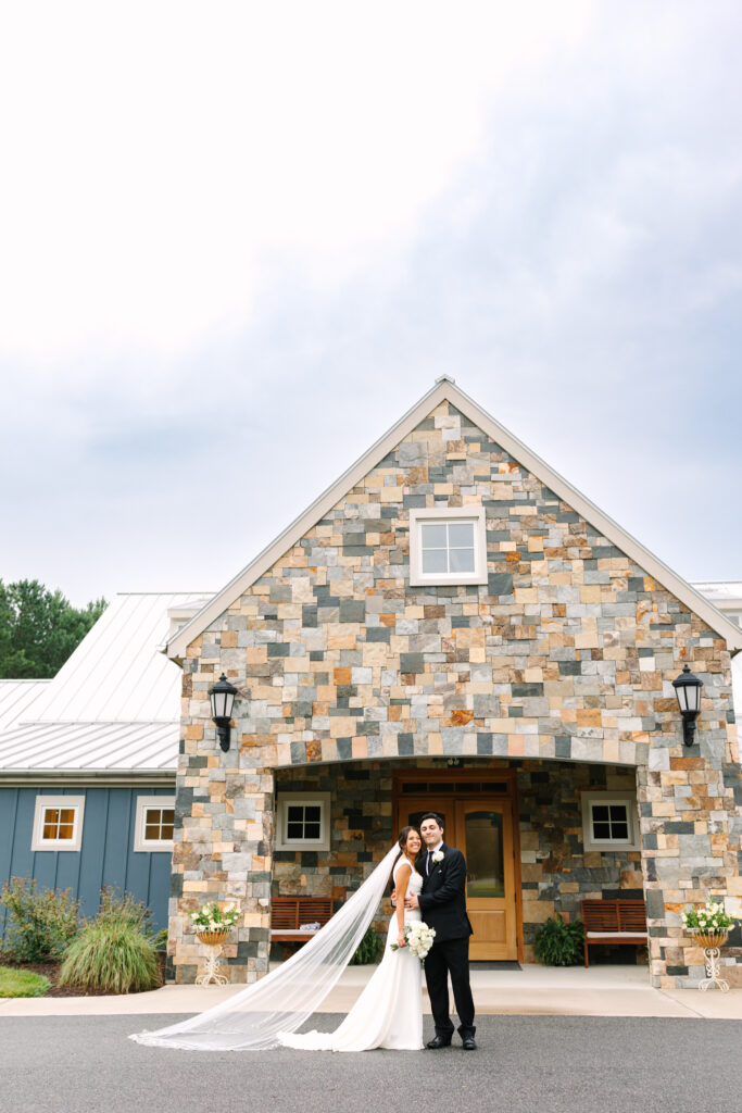 Bride and groom standing in front of The Maine of Williamsburg during their wedding