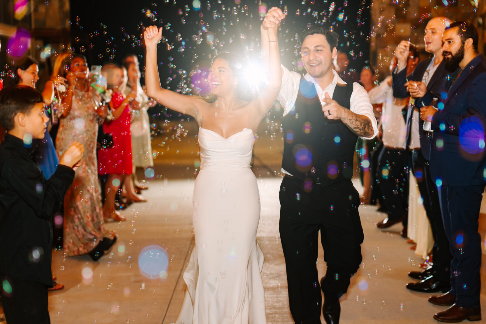 Bride and groom walking through a bubble send-off at The Maine of Williamsburg