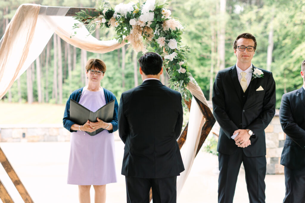 Groom facing away as the bride approaches before the ceremony at The Maine of Williamsburg