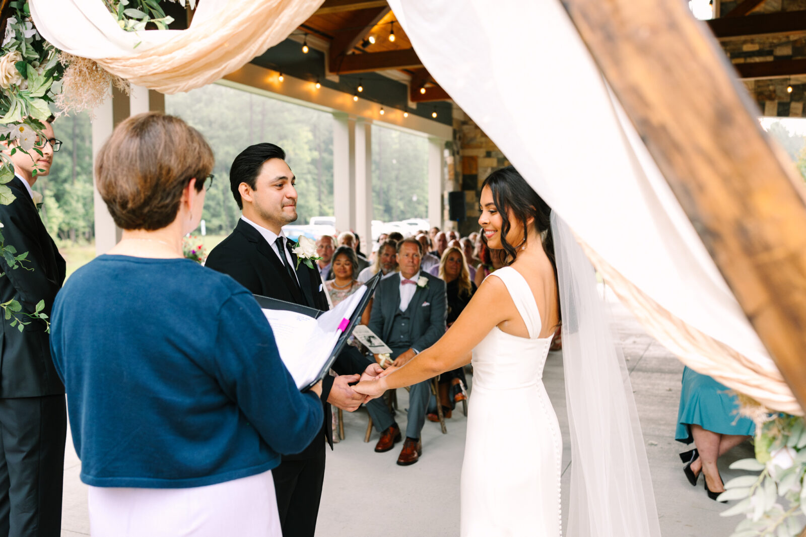 Wedding ceremony photographed through the arch at The Maine of Williamsburg