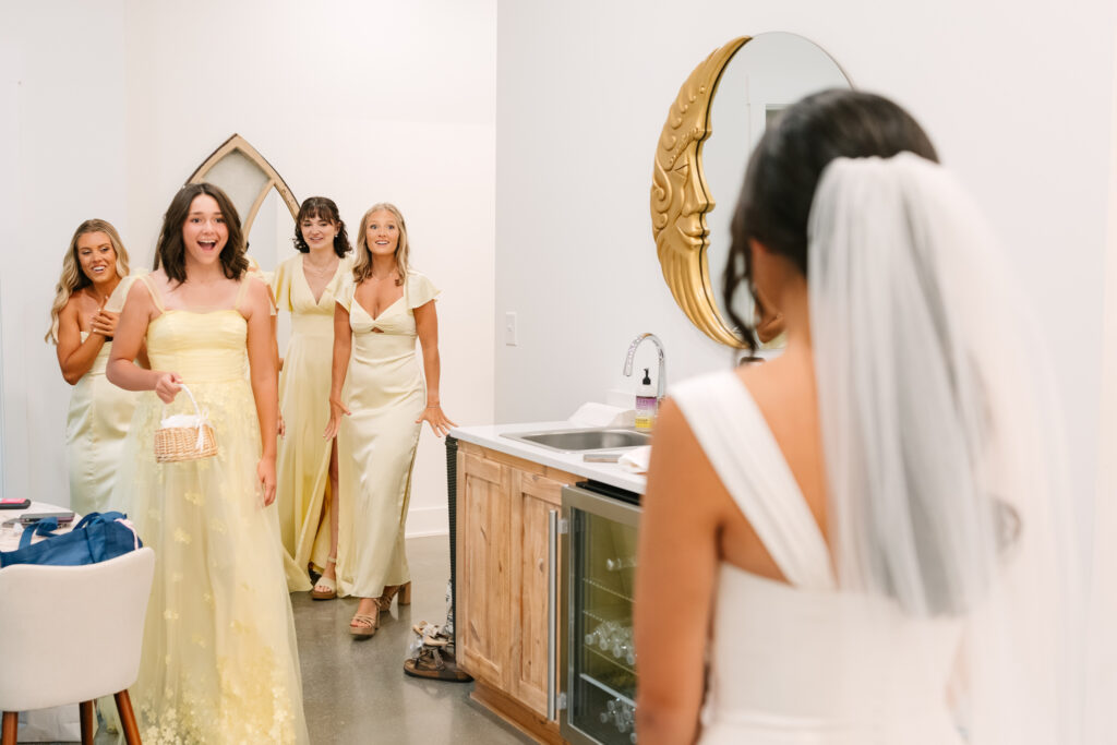 Bride’s first look with bridesmaids and flower girl at The Maine of Williamsburg