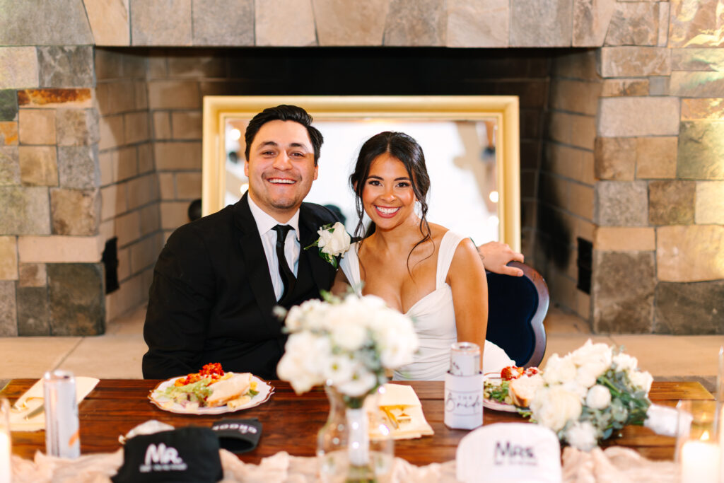 Bride and groom seated at their sweetheart table at The Maine of Williamsburg
