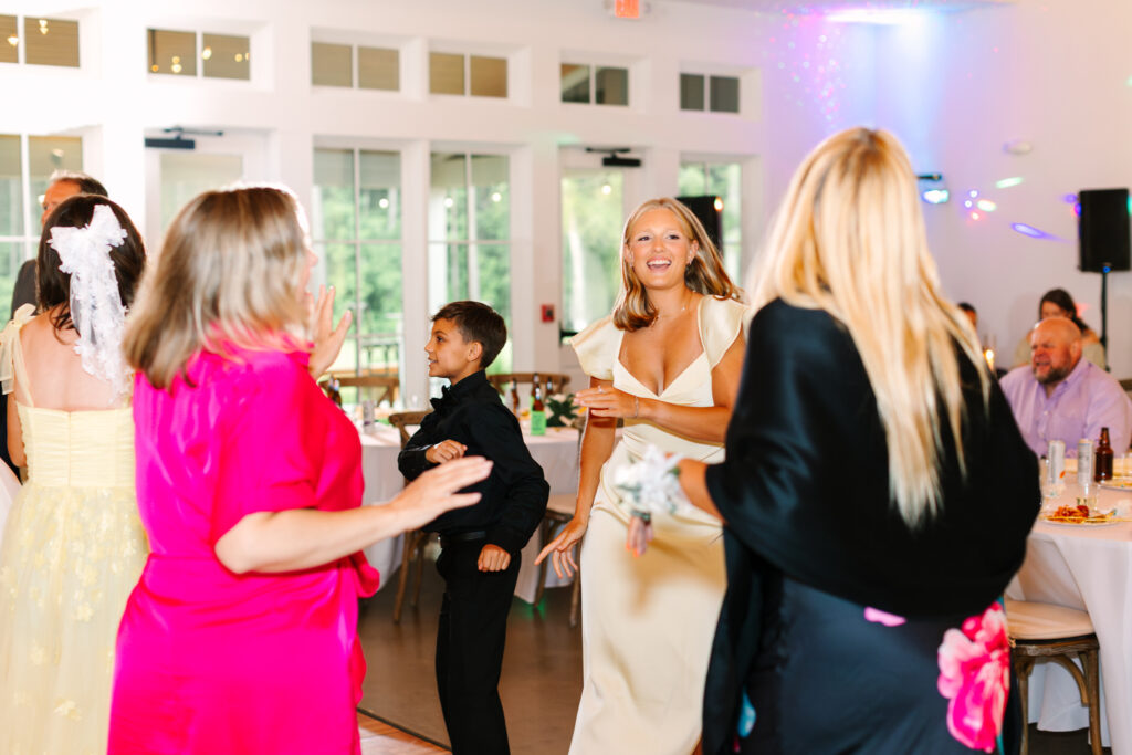 Guests dancing during the wedding reception at The Maine of Williamsburg