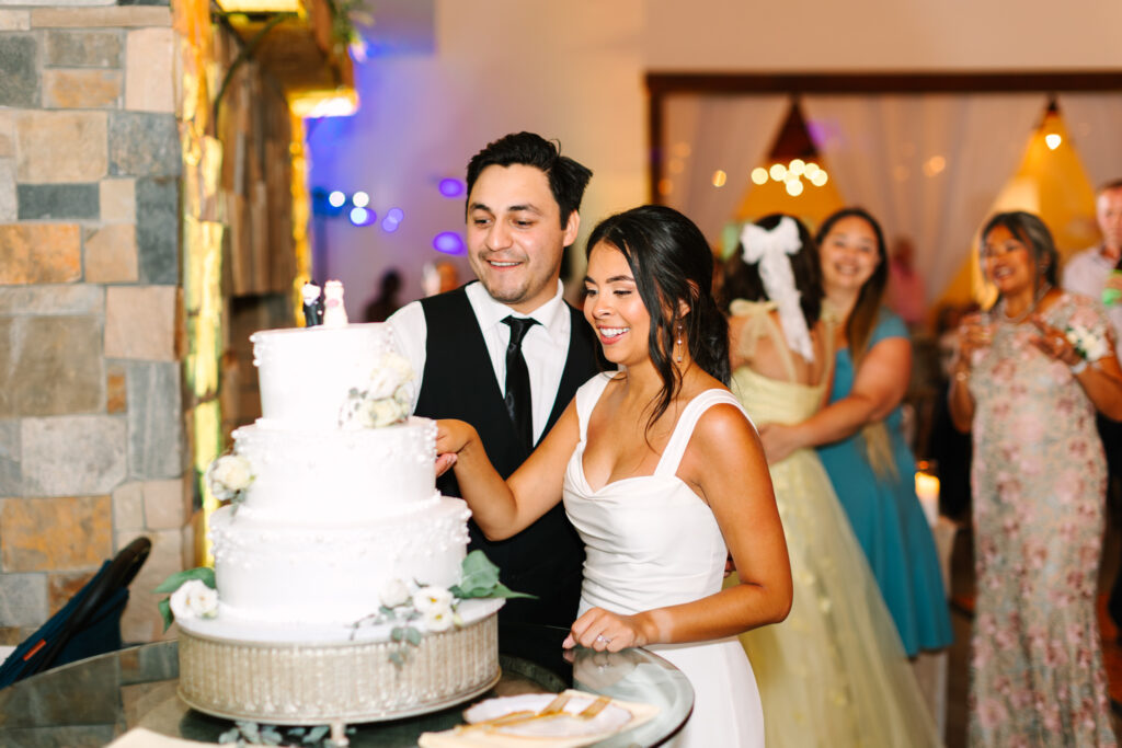 Bride and groom cutting their wedding cake by Sweets by Susan at The Maine of Williamsburg