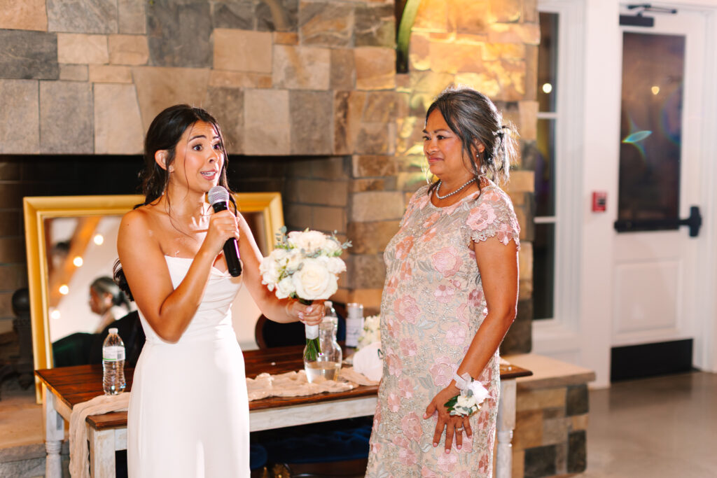 Bride giving her bouquet to her mother during the wedding reception at The Maine of Williamsburg