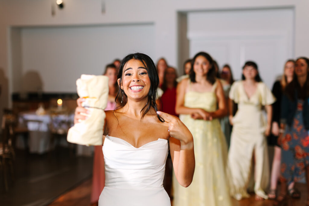 Bride doing a t-shirt toss instead of a bouquet at The Maine of Williamsburg