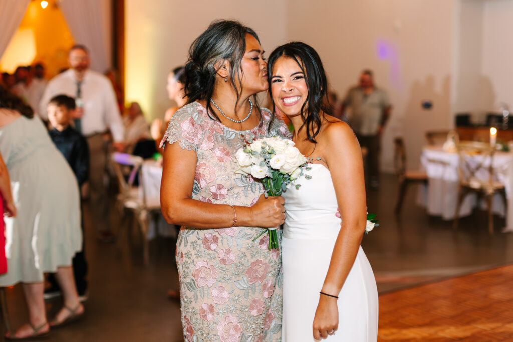 Bride thanking her mother with her bouquet during the reception at The Maine of Williamsburg